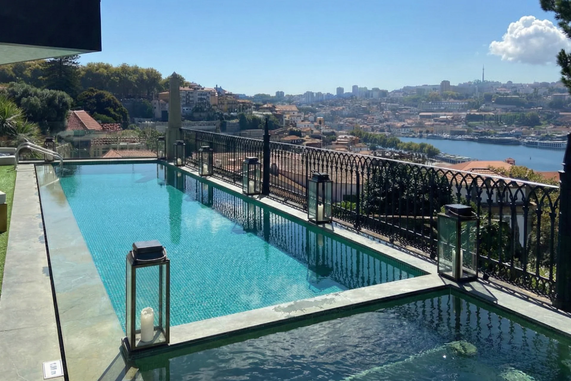 Hotel pool and jacuzzi with panoramic views of the Douro River and Porto cityscape